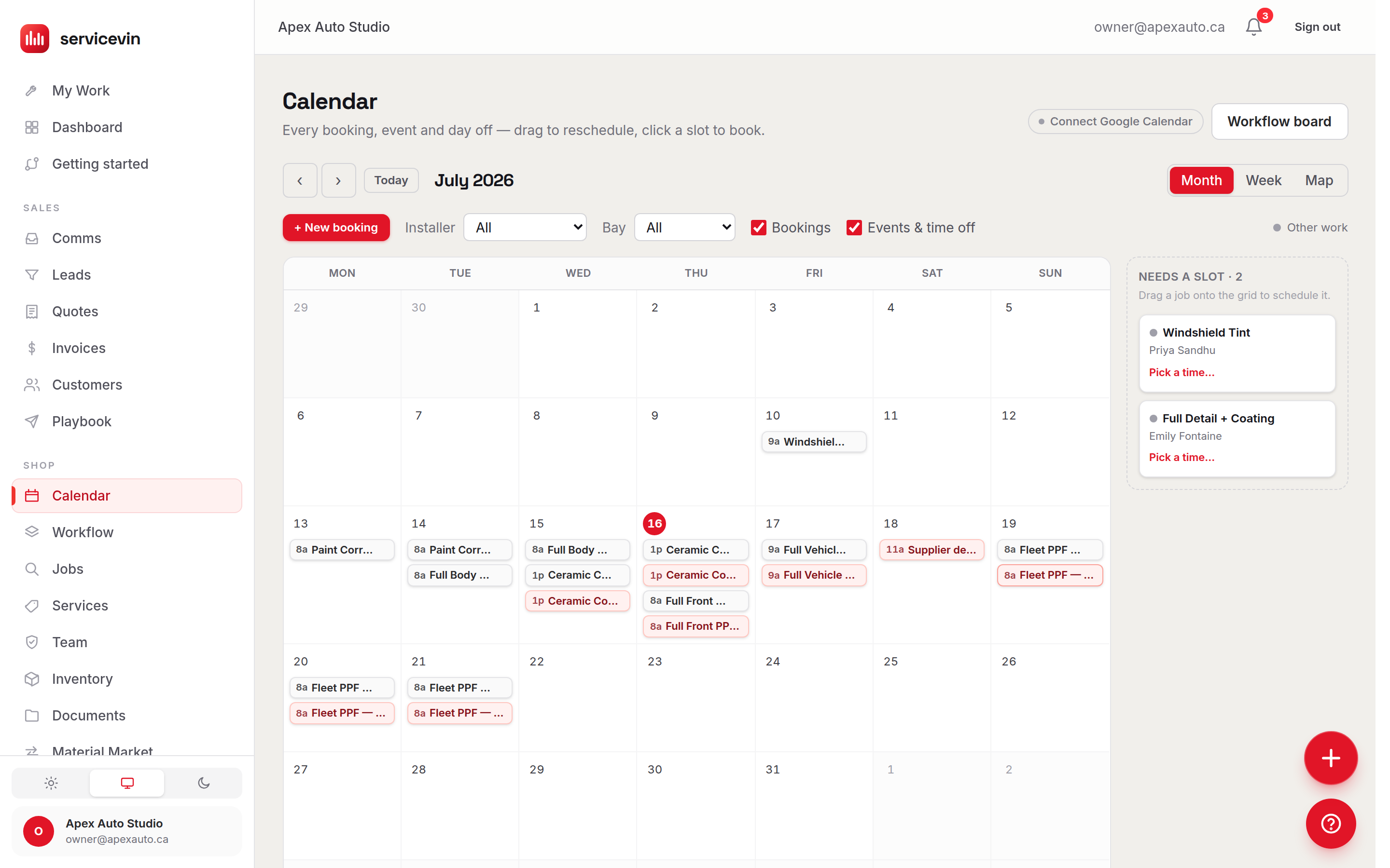 The shop calendar in month view: July laid out week by week with colour-coded bookings, an installer and bay filter above it, and a 'Needs a slot' tray listing two jobs waiting to be dragged onto the grid